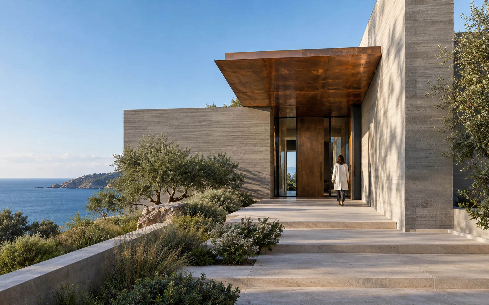 Sculptural concrete residence with a copper canopy overlooking the coast